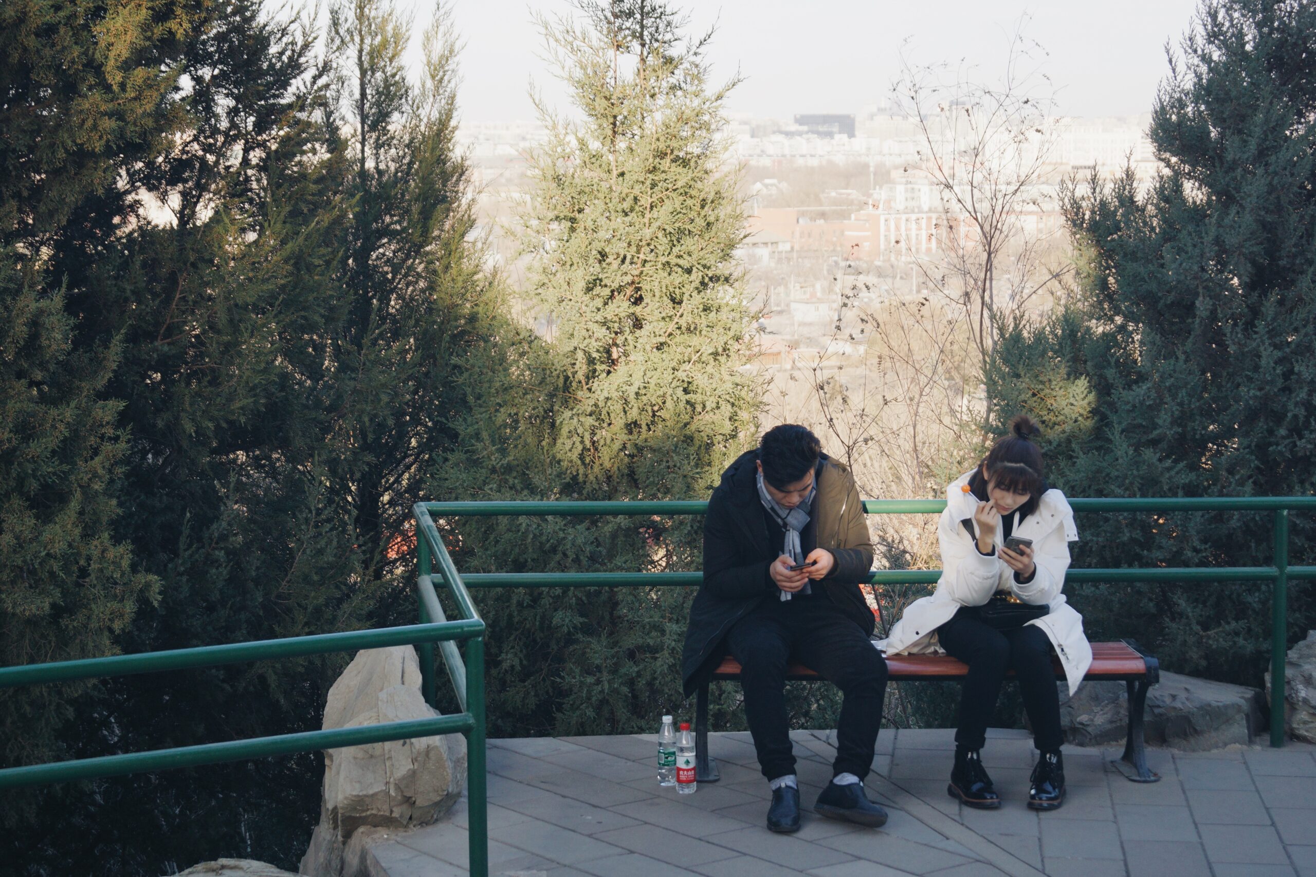 A man and woman sitting on bench