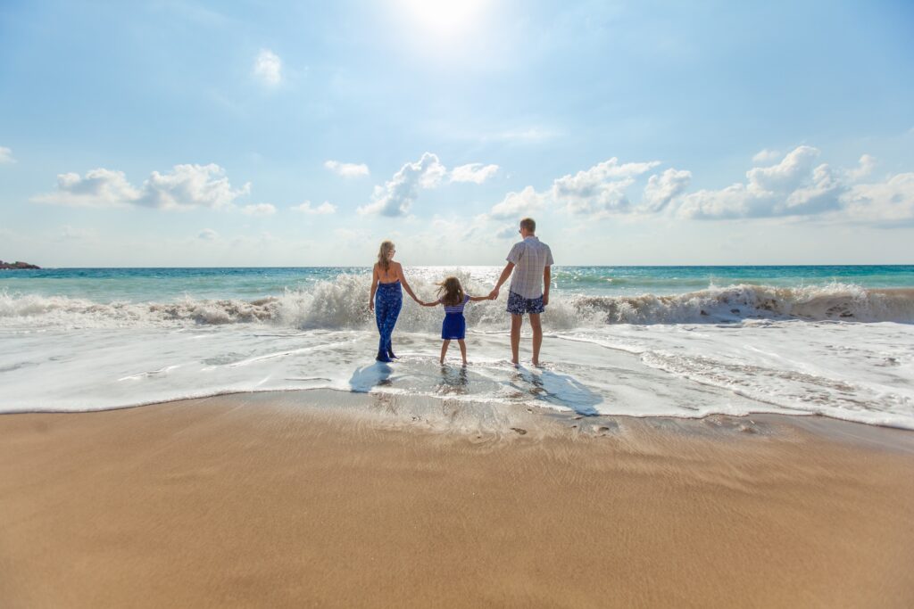 A man, woman and a child on a beach