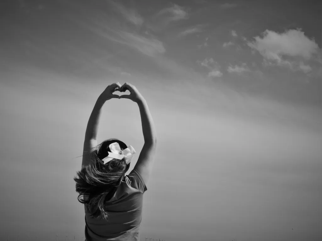 Woman making a finger heart